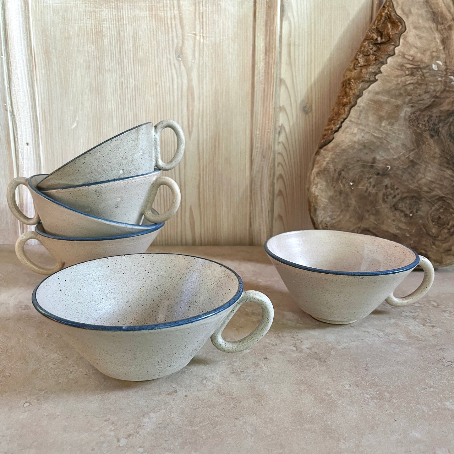 Studio pottery cups with blue rim
