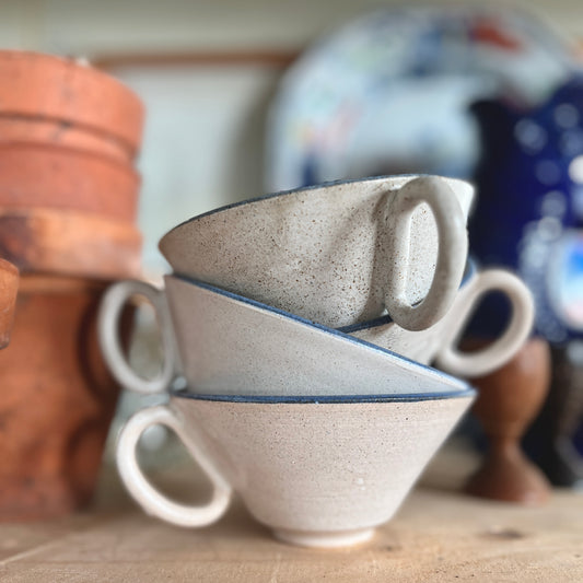 Studio pottery cups with blue rim