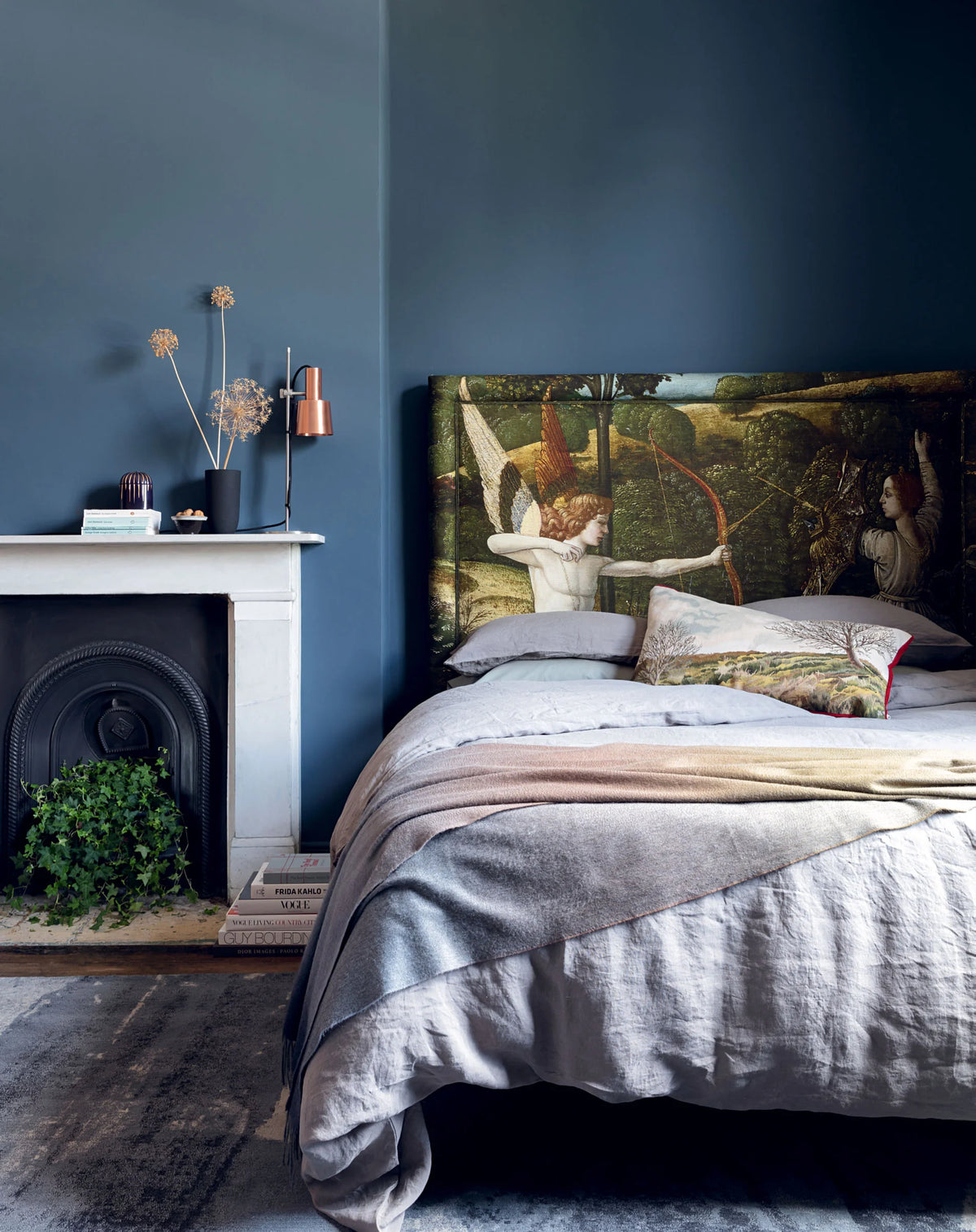 Interior styling by Ida Jacobsson-Wells for Harrods Home & Property, featuring a Vispring bed with an art headboard in a blue bedroom